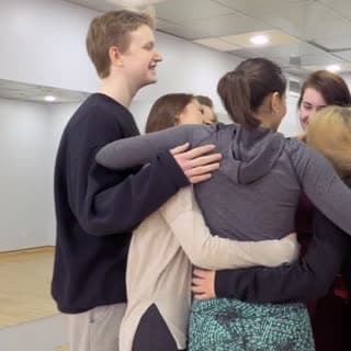 A diverse team sharing a group hug