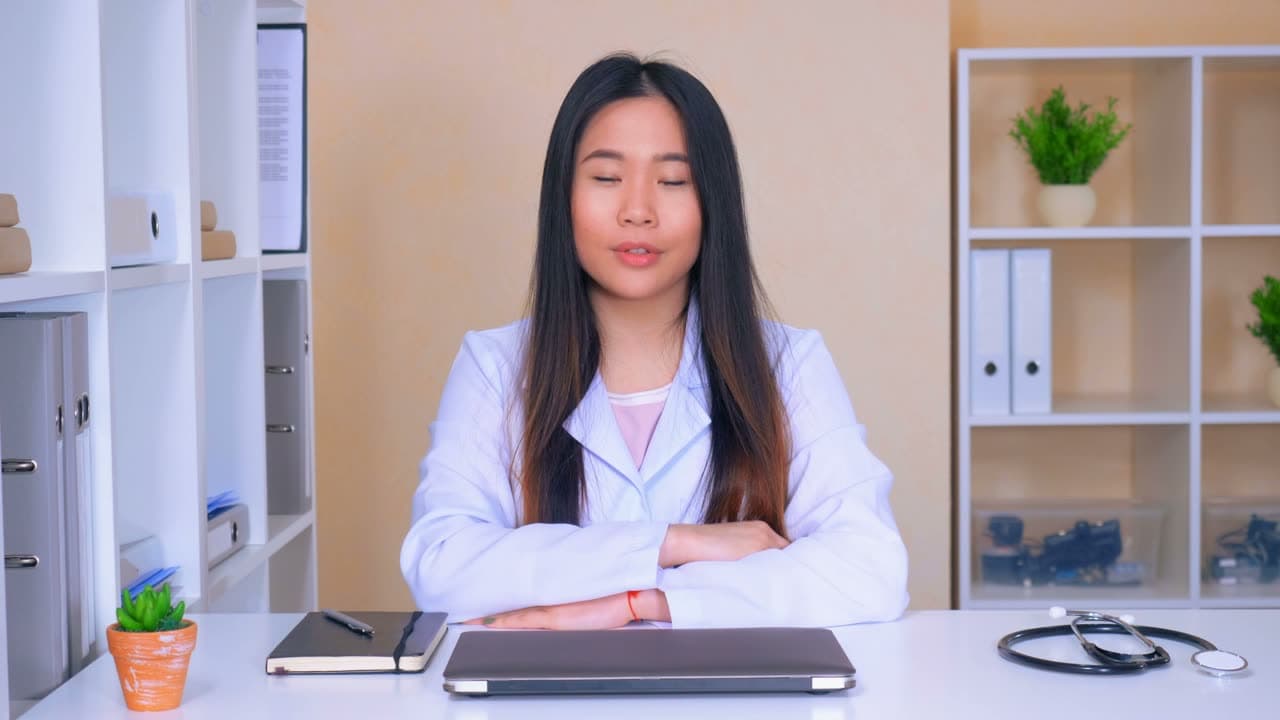 A physician at her desk, ready to listen